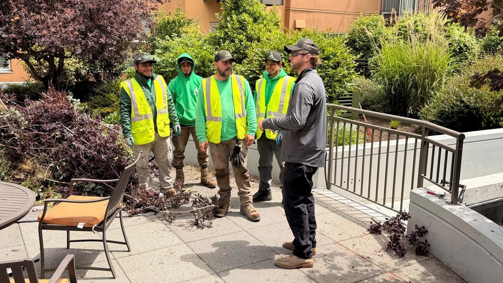 Professional landscape crew maintaining a planted outdoor area
